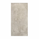 Element Coach Smoke porcelain slab displayed on easel against luxury backdrop showing smoky grey natural stone surface with terrazzo-like texture for UAE interior design