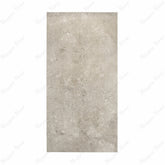 Element Coach Smoke porcelain slab displayed on easel against luxury backdrop showing smoky grey natural stone surface with terrazzo-like texture for UAE interior design