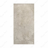 Element Coach Smoke porcelain slab displayed on easel against luxury backdrop showing smoky grey natural stone surface with terrazzo-like texture for UAE interior design
