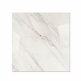 Calcutta Aurora glossy porcelain tile 120x120cm displayed on easel against luxury marble backdrop for UAE interior design