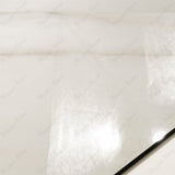 Close-up of Calcutta Aurora glossy porcelain tile showing mirror-polished white marble surface with detailed grey vein clusters and 9mm thickness