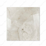 Marbella Gold glossy porcelain tile 120x120cm displayed on easel against luxury marble backdrop for UAE interior design