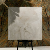 Marbella Gold 120x120cm glossy porcelain tile flat view showing translucent ivory onyx surface with golden agate-like banding