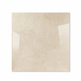 Marfil Pearl glossy porcelain tile 120x120cm displayed on easel against luxury marble backdrop for UAE interior design