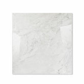 Silver Fume glossy porcelain tile 120x120cm displayed on easel against luxury marble backdrop for UAE interior design