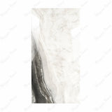 Agata Onyx BM porcelain slab displayed on easel against luxury backdrop showing ivory and charcoal agate stone with dramatic banded movement for UAE interior design