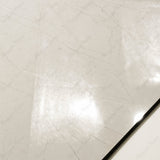 Close-up of Elegant Crema glossy porcelain tile showing mirror-polished cream marble surface, fine vein detail, and 9mm thickness