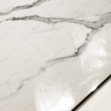 Close-up of Statuario Hexa glossy porcelain tile showing mirror-polished white marble surface with detailed grey vein detail and 9mm thickness