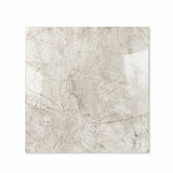 Breccia Bianco glossy porcelain tile 120x120cm displayed on easel against luxury marble backdrop for UAE interior design