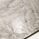 Close-up of Breccia Bianco glossy porcelain tile showing mirror-polished marble surface with detailed dark vein clusters and 9mm thickness.