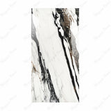 Calacatta Oyster BM porcelain slab displayed on easel against luxury backdrop showing white marble with dramatic black and copper veining for UAE interior design