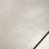 Meera Grey matte porcelain tile 120x120cm displayed on easel against luxury marble backdrop for UAE interior design