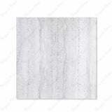 Stonex Grey matte porcelain tile 120x120cm displayed on easel against luxury marble backdrop showing terrazzo aggregate texture for UAE interiors