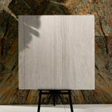 Close-up of Roma Travertino Bianco matte porcelain tile showing detailed travertine texture, natural pores, and 9mm thickness