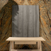 Close-up of Mosaici Natural wood-look porcelain plank showing detailed vertical pine grain, knot detail, and cool grey weathered tones