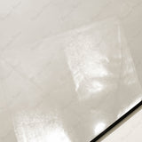 Close-up of Onyx Helio glossy porcelain tile showing mirror-polished translucent ivory surface, delicate cloud-like veining, and 9mm thickness
