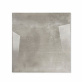 Portland Grey glossy porcelain tile 120x120cm displayed on easel against luxury marble backdrop for UAE interior design