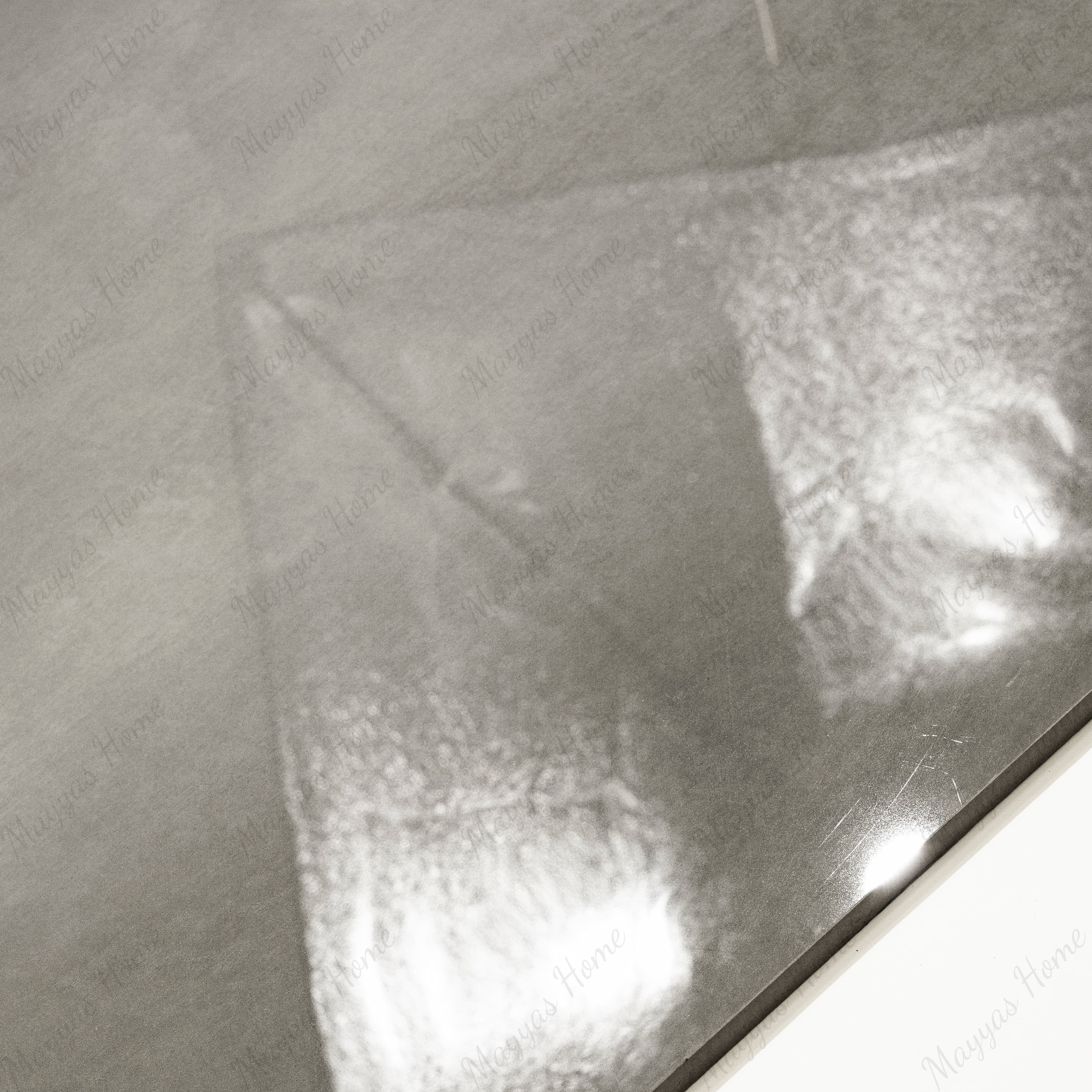 Close-up of Portland Grey glossy porcelain tile showing mirror-polished warm grey cement-look surface and 9mm thickness