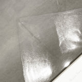 Close-up of Portland Grey glossy porcelain tile showing mirror-polished warm grey cement-look surface and 9mm thickness