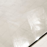 Close-up of Melton Bianco glossy porcelain tile showing mirror-polished ivory marble surface with subtle flowing veining and 9mm thickness