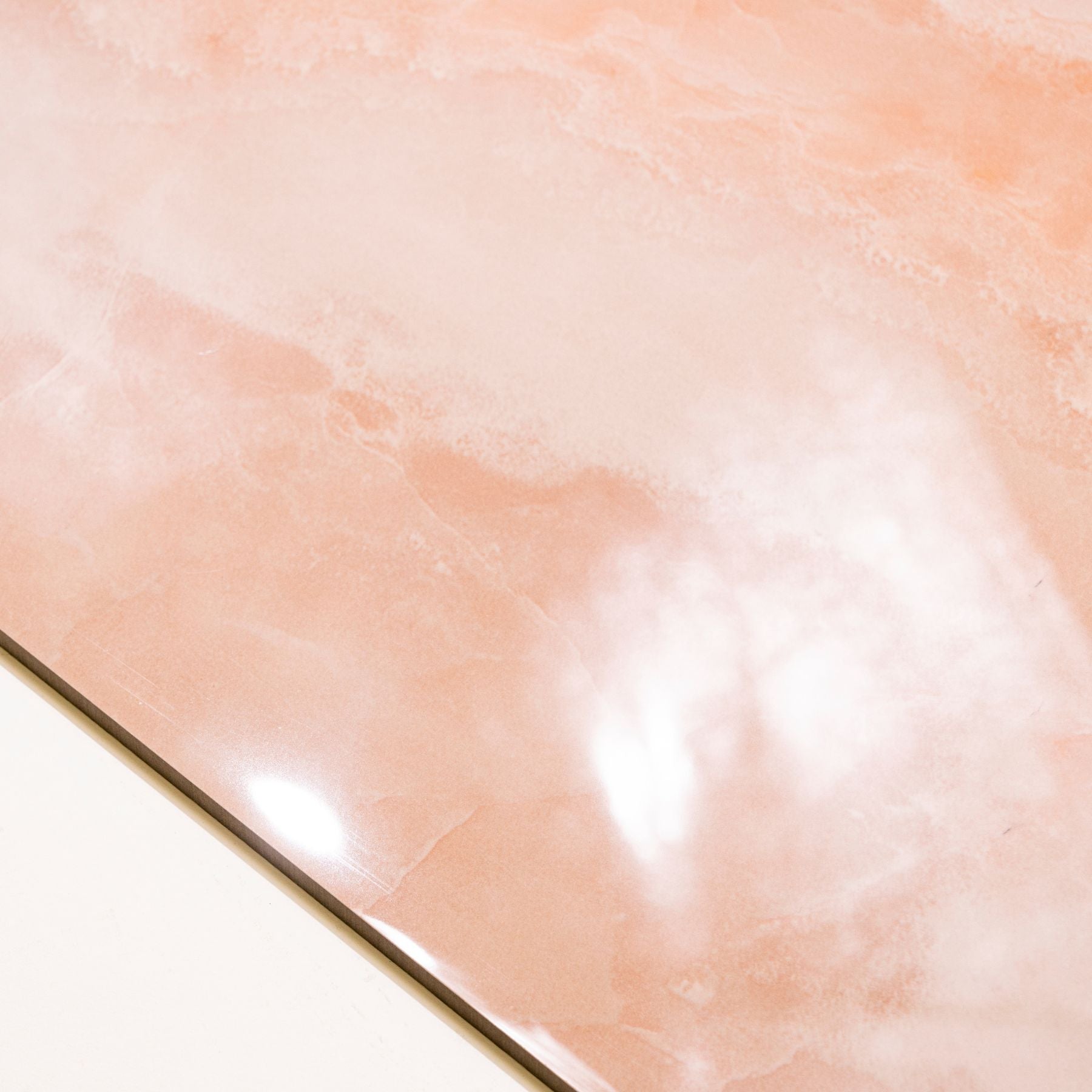 Coral Onyx glossy onyx effect porcelain tile 60x120cm with 9mm thickness features warm coral tones and polished luxury finish.